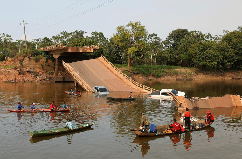 Local people and rescue workers navigate boats in the Curuca River after a bridge collapsed on the BR-319 highway in Careiro da Várzea, near Manaus, on Sept. 28.