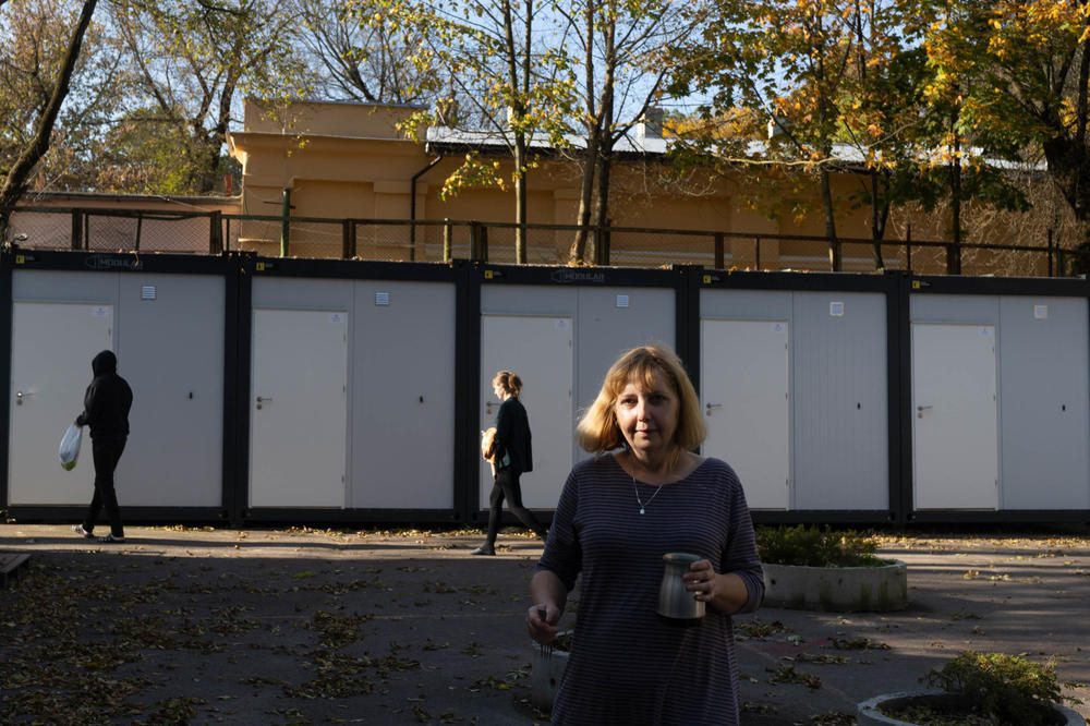 Hanna Korchevska carries a pitcher of water back to the family's room in Lviv.