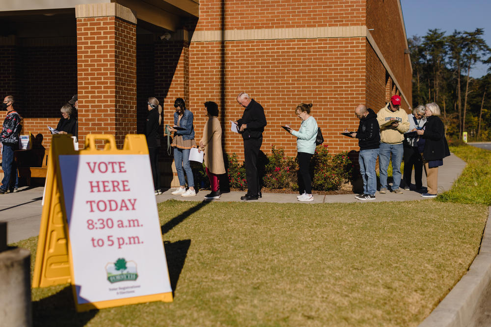 People in line at a polling location at the Elections and Voter Registration Office in Cumming, Ga.