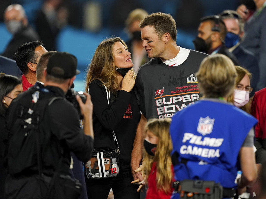 Tampa Bay Buccaneers quarterback Tom Brady walks with Gisele Bundchen on the field in February 2021 after winning the Super Bowl against the Kansas City Chiefs.