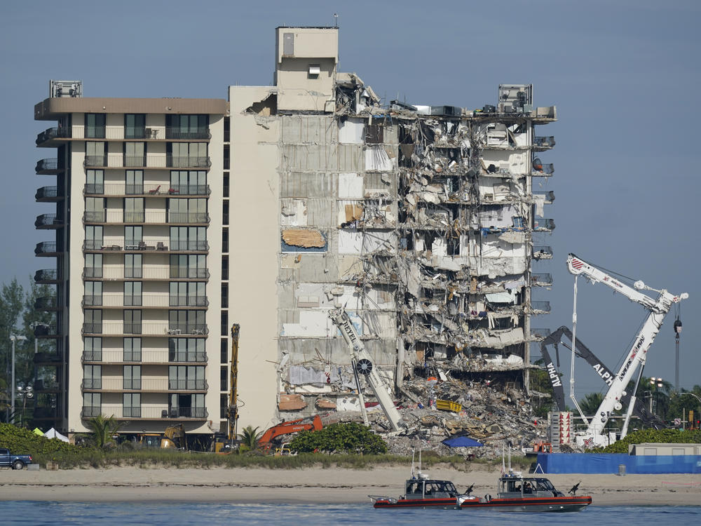 Coast Guard boats patrol in front of the partially collapsed Champlain Towers South condo building in Surfside, Fla. in July 2021. Residents of a Miami Beach building on the same street were forced to evacuate on Thursday evening.