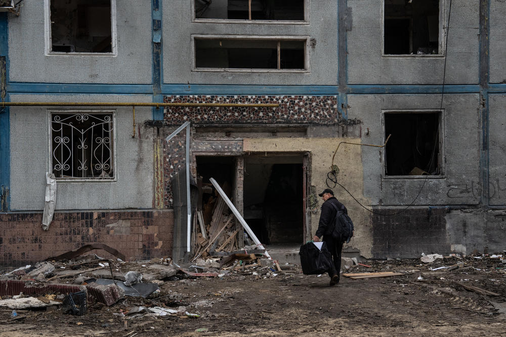 A man enters an apartment block in Zaporizhzhia on Friday that was destroyed after being hit by a Russian missile.