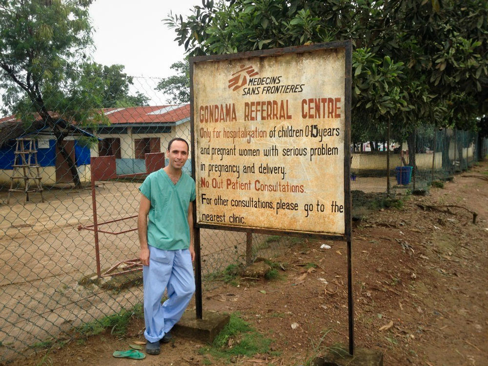 Dr. Benjamin Black in front of the Gondama Referral Center in Sierra Leone, where he worked during the Ebola outbreak of 2014-2016. The center treated children and women in urgent need of obstetric and gynecological care. As the outbreak exploded, the center decided to stop admitting pregnant women, a decision that still weighs on Black.