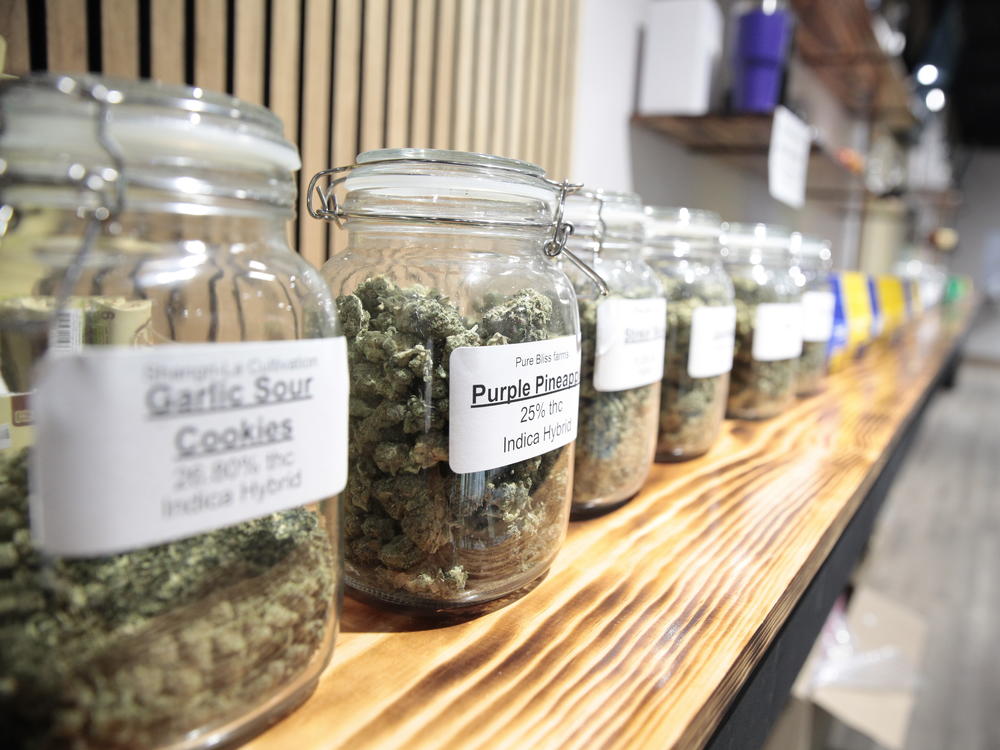 Jars of marijuana line a shelf at The Flower Shop Dispensary in Sioux Falls, S.D. on Oct. 14, 2022. South Dakota's legal pot industry has started with medical cannabis, but voters are deciding whether to also legalize recreational pot.