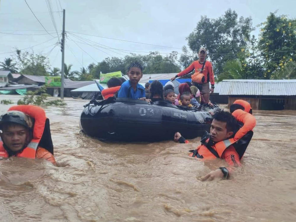 Rescuers use boats to evacuate residents from flooded areas due to Tropical Storm Nalgae at Parang, Maguindanao province, southern Philippines on Friday.