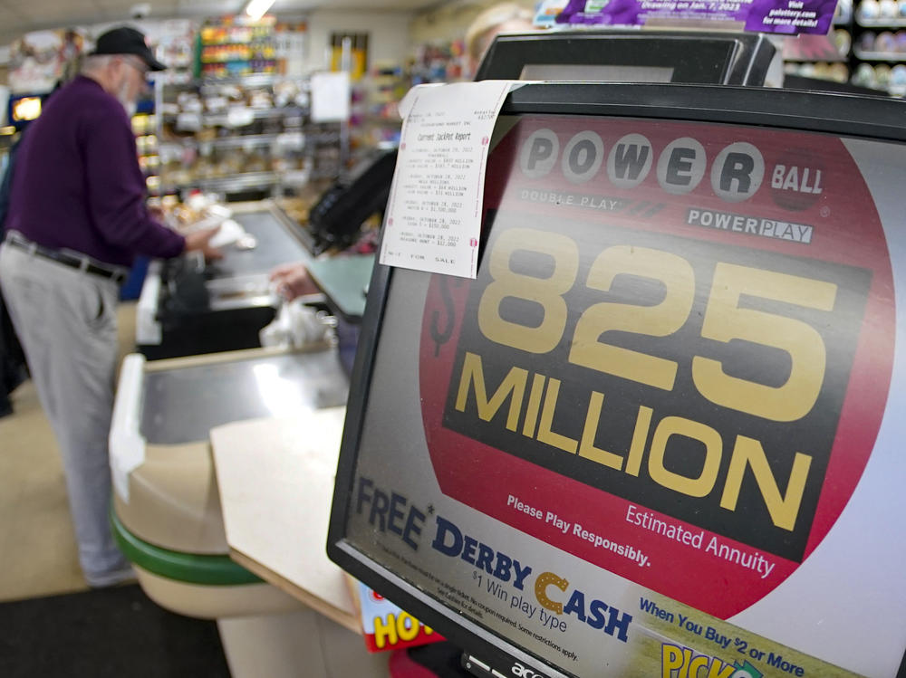 Dave Colbert pays for his groceries at a market in Prospect, Pa., on Friday before buying a ticket for Saturday's Powerball drawing.