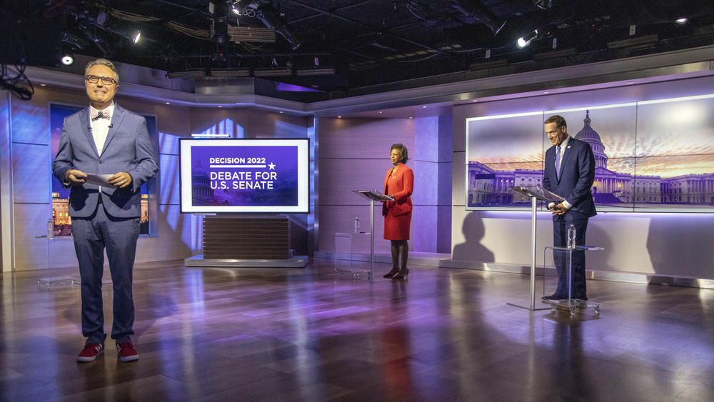 Spectrum News 1 political anchor Tim Boyum, left, prepares to moderate a debate between Democratic candidate for U.S. Senate Cheri Beasley, center, and Republican Rep. Ted Budd, R-N.C., on Oct. 7 in Raleigh, N.C.