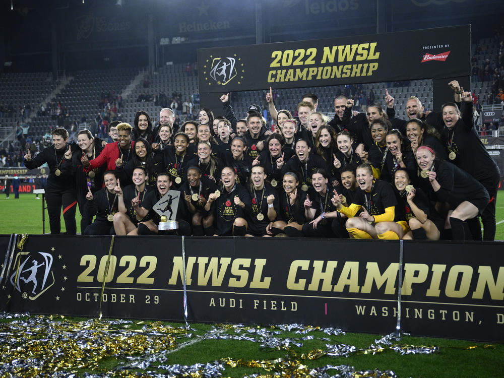 The Portland Thorns pose with the trophy after the team won the National Women's Soccer League championship match against the Kansas City Current on Saturday in Washington, D.C. Portland won 2-0.