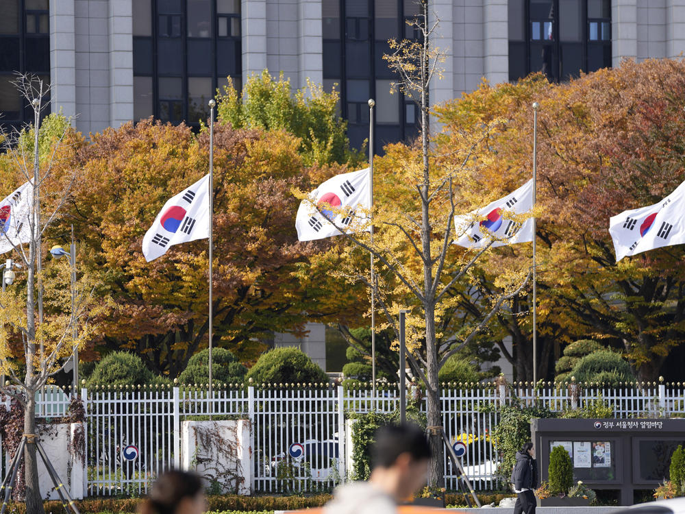 South Korean national flags fly at half-mast at the government complex in Seoul, South Korea, Sunday, Oct. 30, 2022.