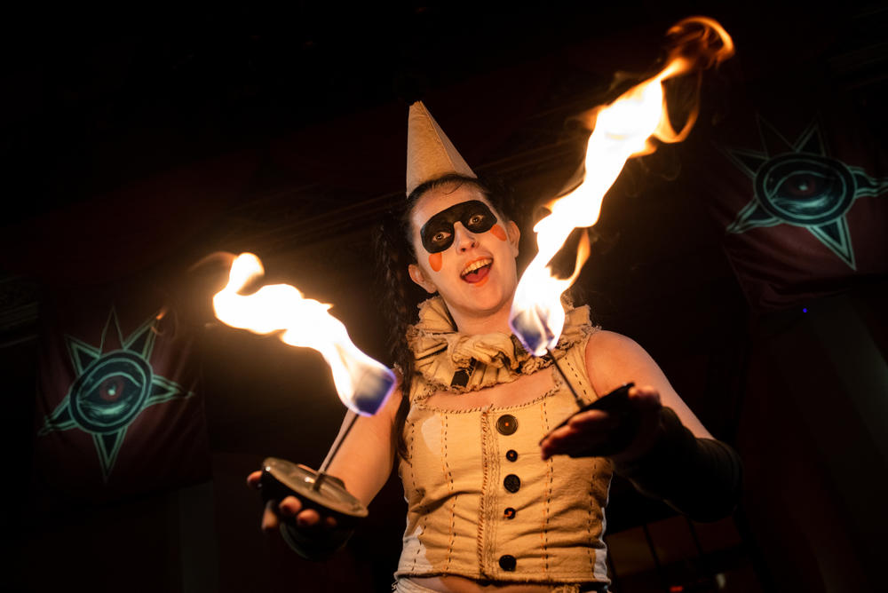 A performer dances with fire.