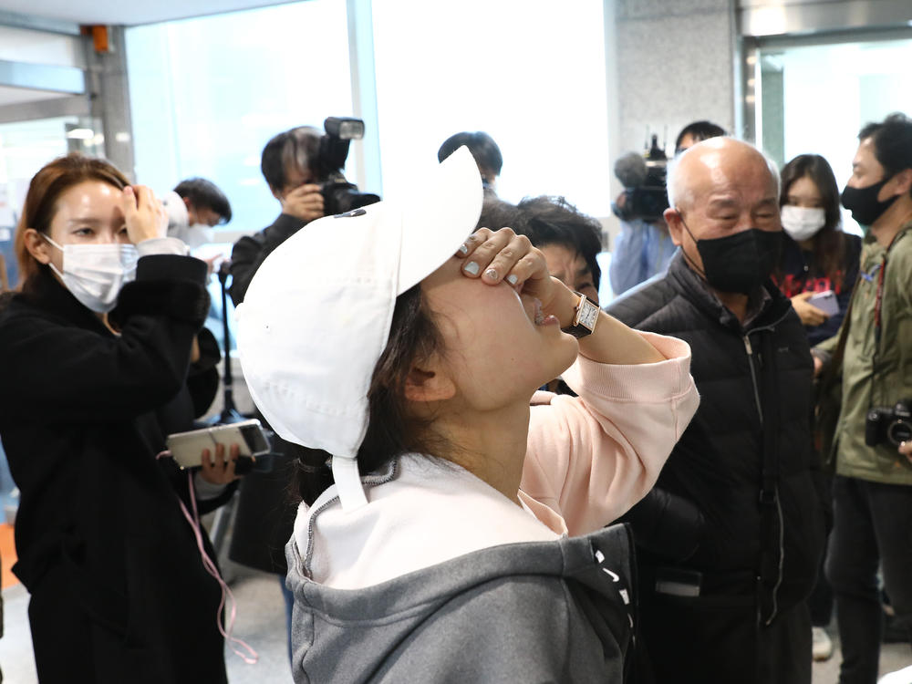Relatives of missing people weep at a community service center in Seoul, South Korea.