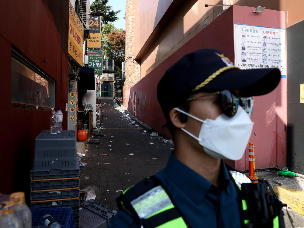 A police officer stands on patrol at the scene of the deadly stampede during a Halloween festival.