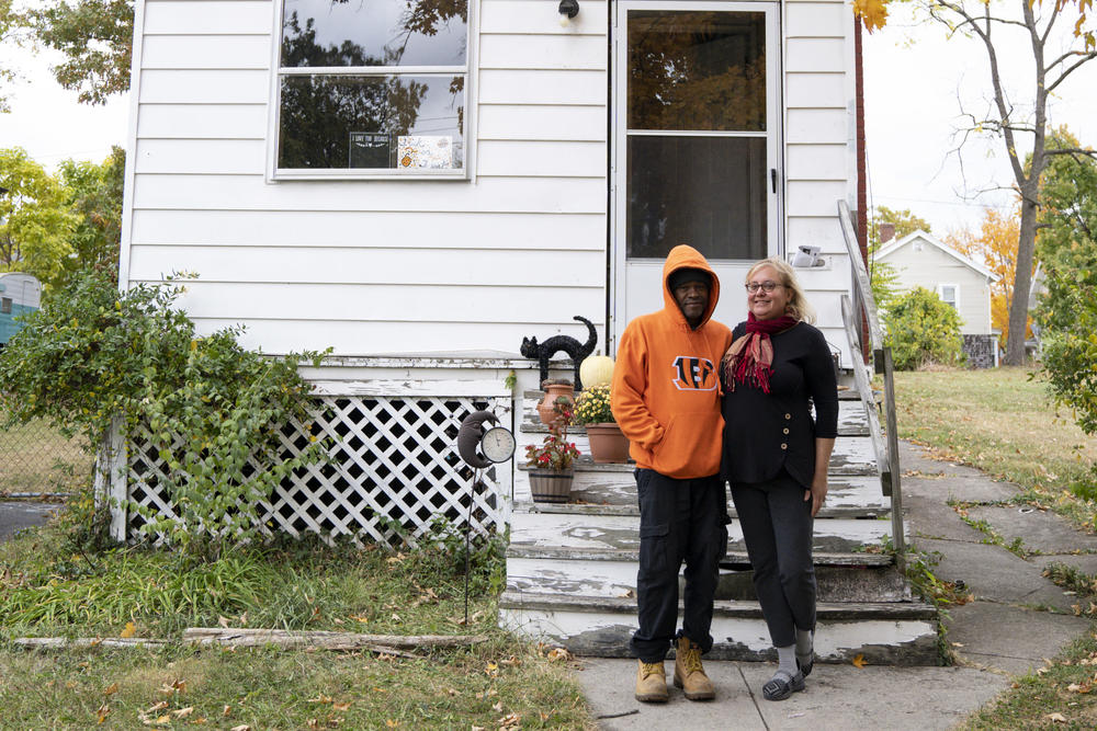 Derrick Davidson (left) and Carolyn Perkins, pictured outside the home they rent, say they've worried that gentrification is pricing them out of their neighborhood. But now they hope they'll be able to buy their house at below-market cost from The Port of Greater Cincinnati.