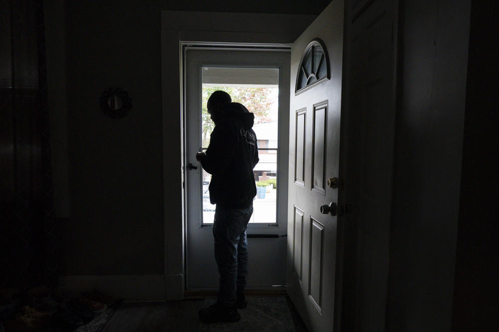Demetrius Harper-Edwards stands in the doorway of the home he and his girlfriend rent. They hope to soon buy the place at an affordable price from the local agency that now owns it.