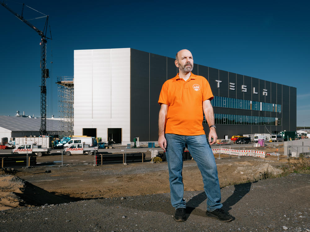 Local activist and politician Thomas Loeb, 55, in front of the Tesla factory in Gruenheide on Oct. 26. Loeb is concerned that the factory poses a risk to the groundwater, forest and wildlife around it, and that Tesla has not been transparent about its manufacturing processes and developments.