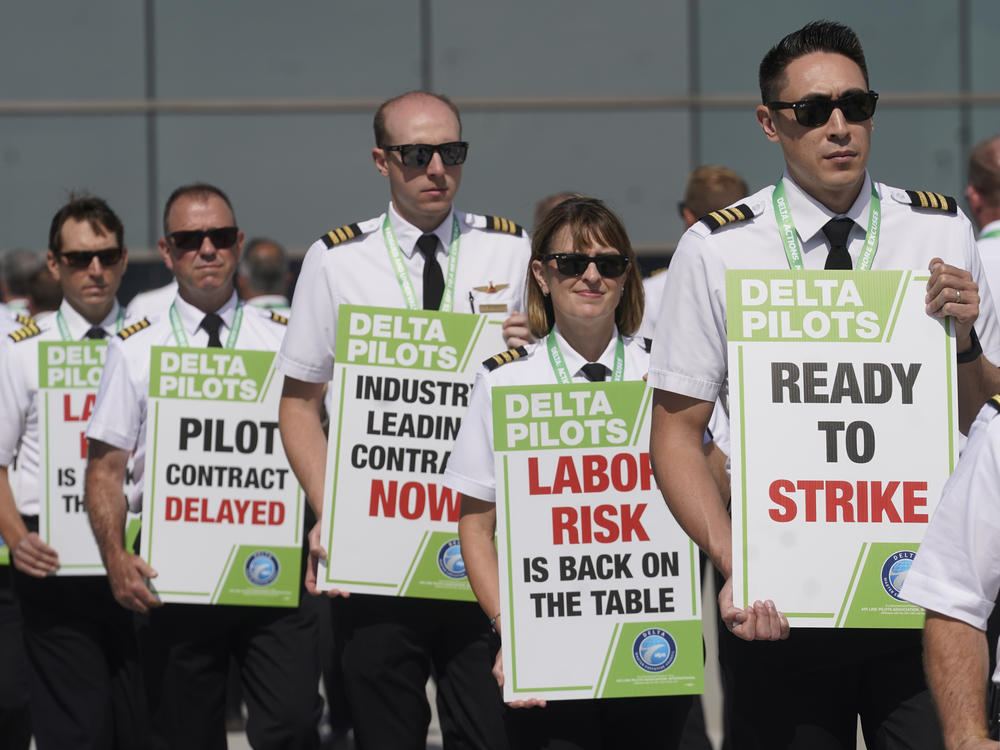 Off-duty Delta Air Lines pilots picket at Salt Lake City International Airport Thursday, June 30, 2022, in Salt Lake City.