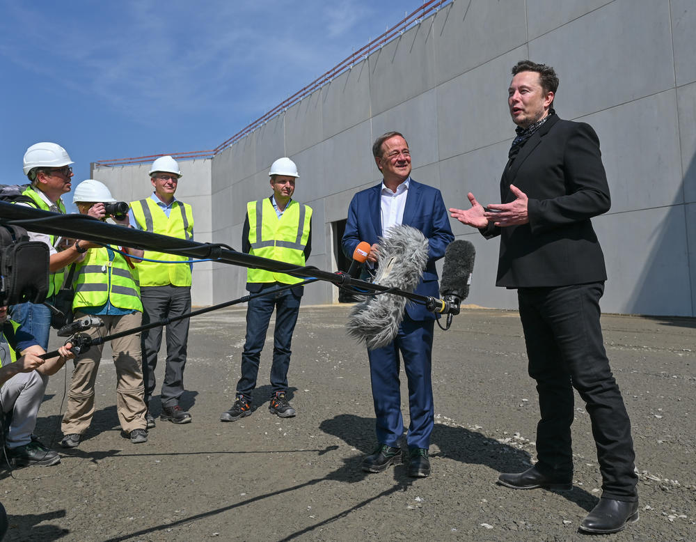 Tesla CEO Elon Musk (right) and Armin Laschet, the prime minister of North Rhine-Westphalia at the time, speak with the press during a tour of the Tesla plant in Gruenheide on Aug. 13, 2021.