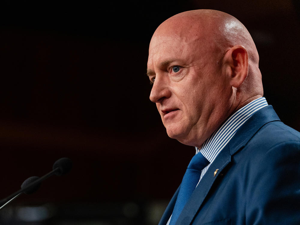 Sen. Mark Kelly, D-Ariz., speaks during a news conference in Washington in July.