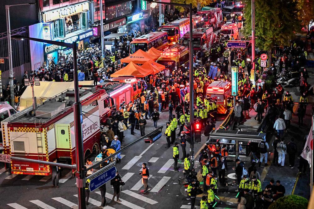 Onlookers, police and paramedics gather in response to a stampede during Halloween celebrations in the popular nightlife district of Itaewon in Seoul on Saturday.