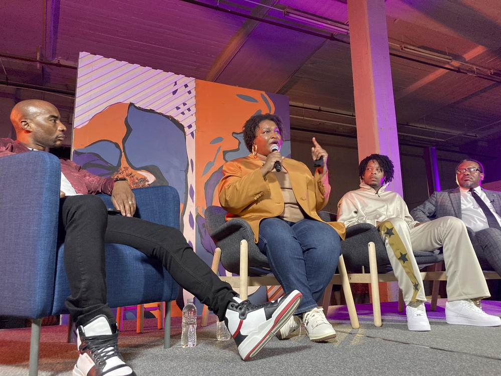 Georgia Democratic candidate for governor Stacey Abrams speaks at a campaign event on Sept. 9 in Atlanta, flanked by radio and TV personality Charlamagne tha God, left, rapper 21 Savage and civil rights lawyer Francys Johnson, right.