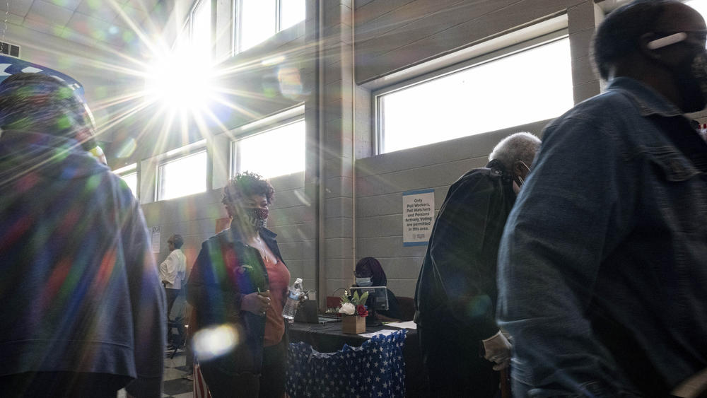 Voters make their way to the polls during the first day of early voting in Atlanta on Oct. 17.