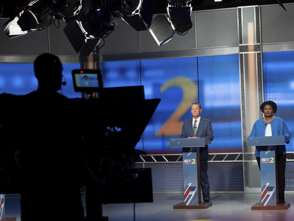 Republican Georgia Gov. Brian Kemp, left, and Democratic challenger Stacey Abrams face off in a televised debate, in Atlanta on Sunday.