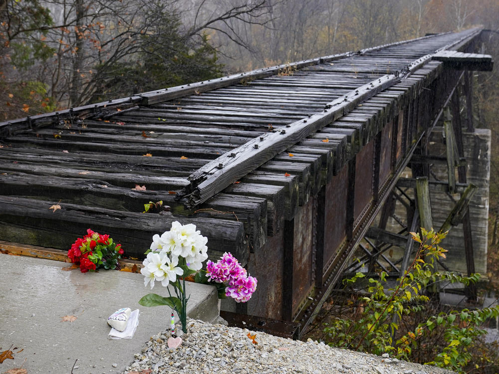 Flowers are placed at the Monon High Bridge Trail in Delphi, Ind., Monday, Oct. 31, 2022, near where Liberty German and Abigail Williams were last seen and where the bodies were discovered.