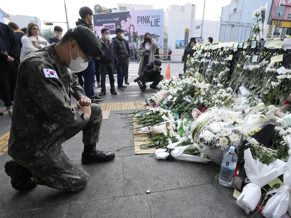 A South Korean army soldier pays tribute to victims of a deadly accident following Saturday night's Halloween festivities on a street near the scene in Seoul, South Korea, Tuesday, Nov. 1, 2022.