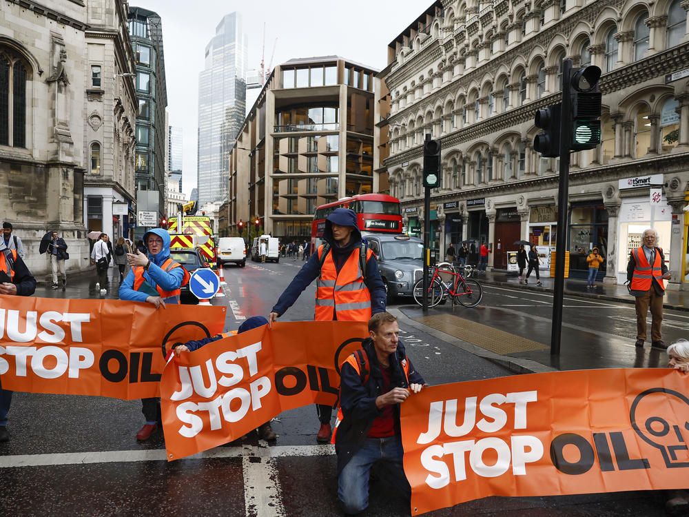 Just Stop Oil protesters block the roads at a major intersection on Thursday in London, England, the latest in its series of public demonstrations.