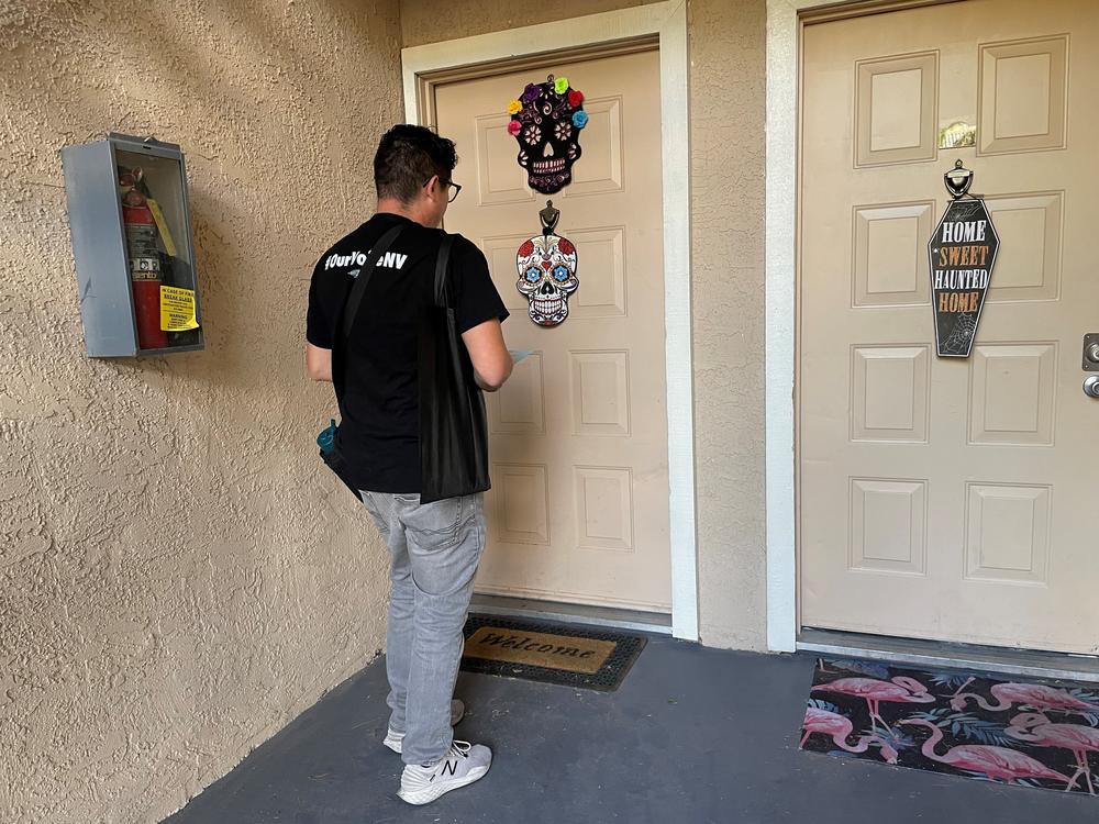 Progressive Activist LaLo Montoya knocks on a door in a Las Vegas apartment complex to help get out the vote ahead of Election Day.