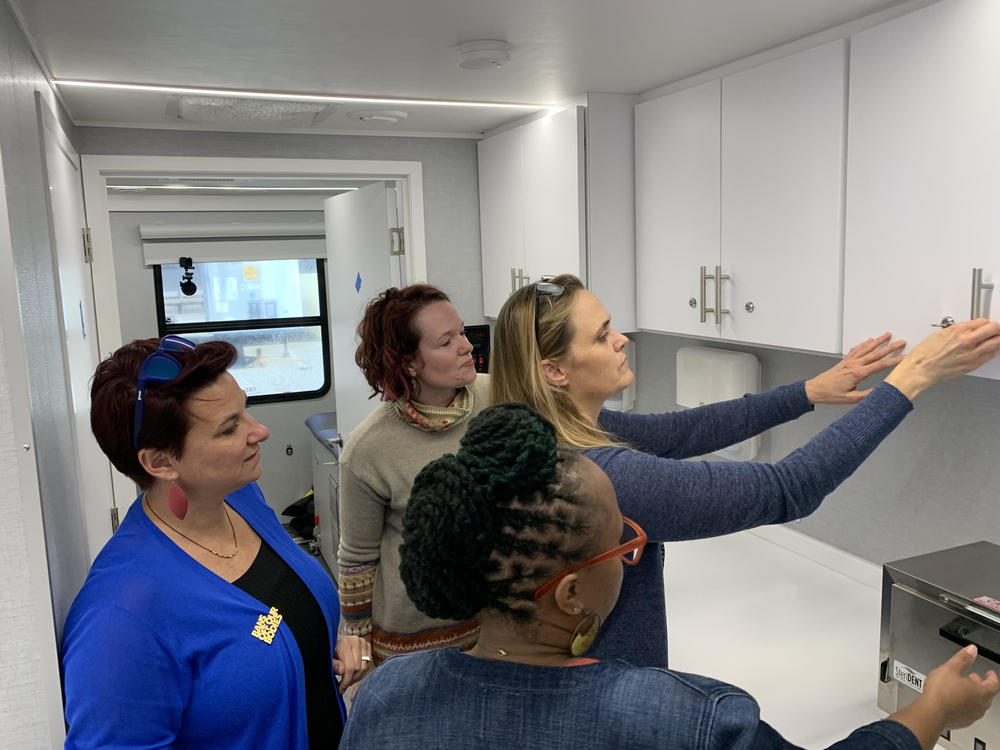 Planned Parenthood, including Dr. Colleen McNicholas, left, and LaQuetta Cooper, right, staff tour the new mobile clinic that will soon provide abortion pills to patients in Illinois.