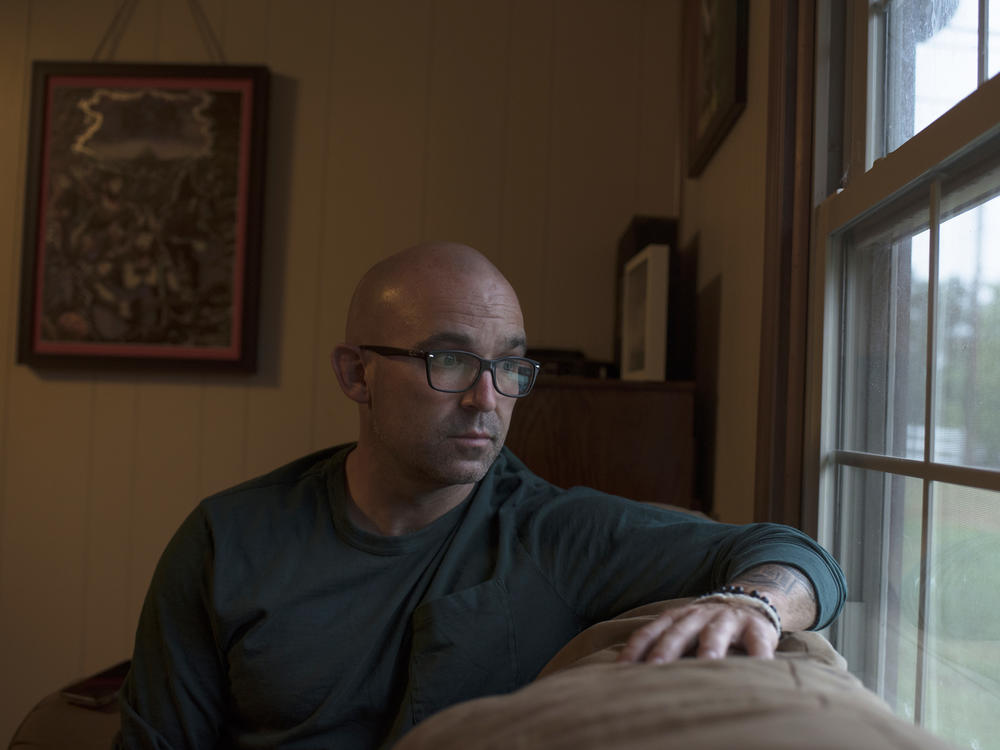 Former social studies teacher Matthew Hawn was accused of insubordination and repeated unprofessional conduct for showing Kyla Jenèe Lacey's poem <em>White Privilege</em> to his contemporary issues class. Hawn sits on his couch inside his home on Aug. 17, 2021.
