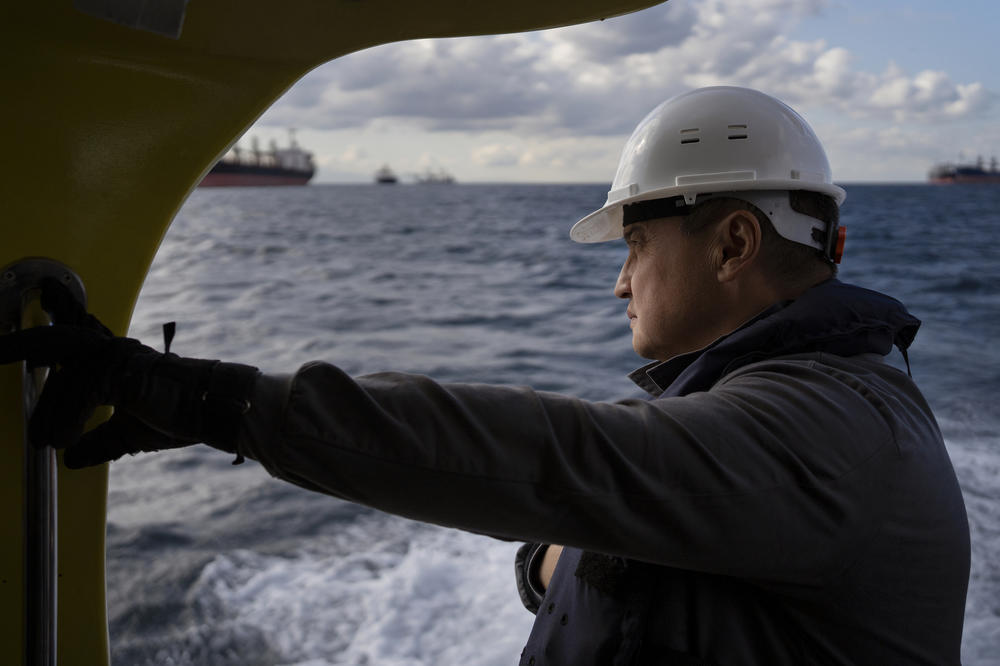 United Nations inspector Shamil Berdaliev looks out from a boat ferrying him and other inspectors. The small ferry weaved through dozens of anchored cargo ships, many awaiting inspections, to the first vessel of the day: the Tzarevich, nearly 220 yards long and carrying 10,000 tons of sunflower meal from Chornomorsk, Ukraine, to Varna, Bulgaria.