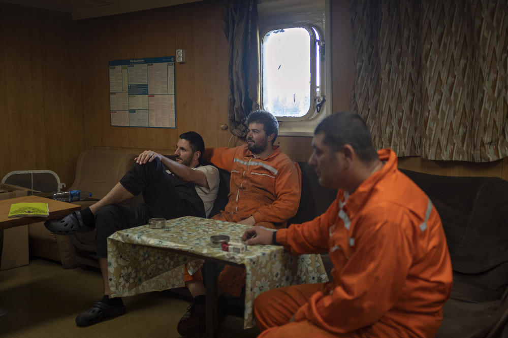 Crew members of the Tzarevich ship watch television.