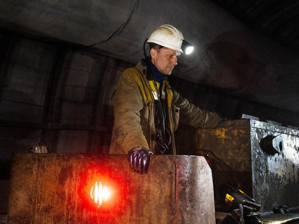 A mine railway operator in Eastern Ukraine waits as workers disembark. Russia's invasion of Ukraine disrupted global supplies of fossil fuels and led to more reliance on coal for electricity in some countries. The future sources of energy around the world are major topics at climate negotiations underway in Egypt starting this week.