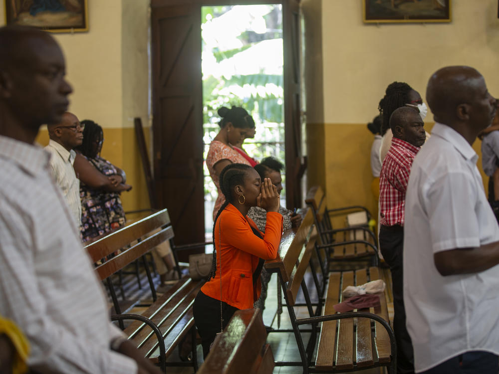 A woman prays during a mass at the St. Pierre church in the Pétion-Ville district of Port-au-Prince, Haiti, on Oct. 23.