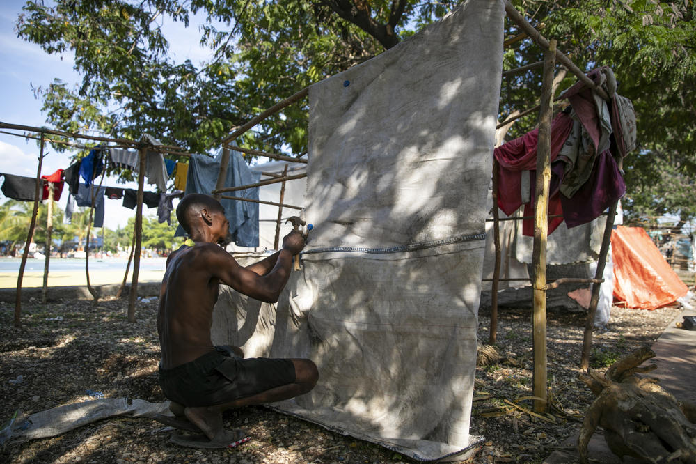 A man fixes his makeshift tent at the Hugo Chávez public square in Port-au-Prince on Oct. 22. The square has transformed into a refuge for families forced to leave their homes due to clashes between armed gangs.