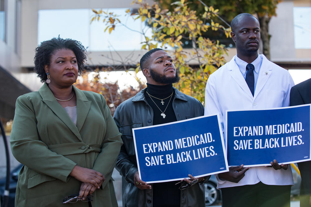 Abrams stands with protestors outside of the closed Wellstar Atlanta Medical Center on Nov. 1. Since 2018, Abrams has advocated for full Medicaid expansion and argued it would have saved many of Georgia's closing hospitals. 