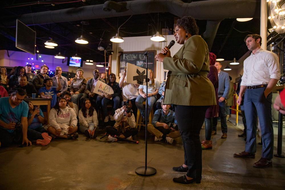 In front of a crowd of supporters in Marietta, Ga., and flanked by U.S. Sen. Jon Ossoff, Abrams emphasizes abortion restrictions by her opponent. After the Supreme Court decided to overturn <em>Roe v. Wade</em>, Georgia's strict abortion ban passed in 2019 went into effect. 