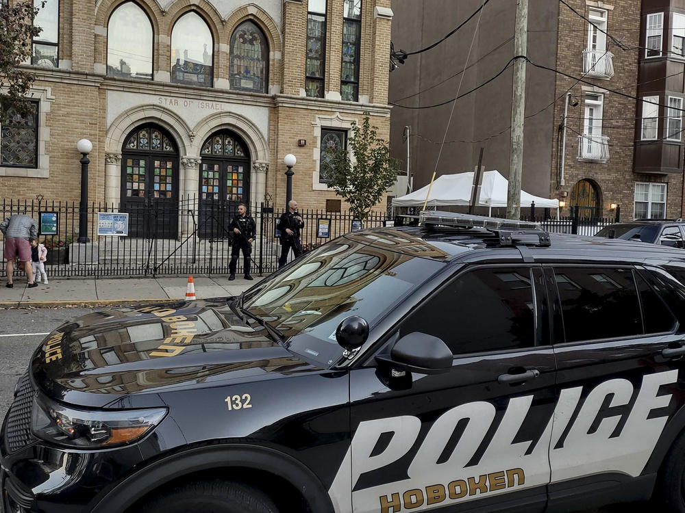 Hoboken Police officers stand watch outside the United Synagogue of Hoboken, Thursday, Nov. 3, 2022, in Hoboken, N.J. The FBI says it has received credible information about a threat to synagogues in New Jersey.