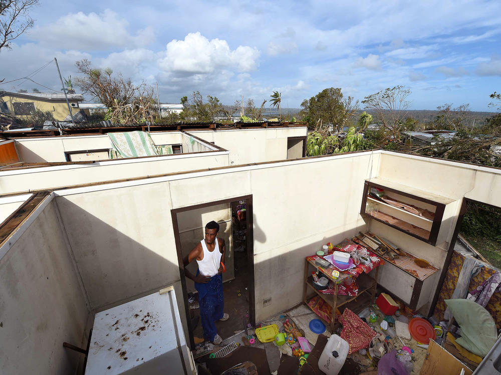 Uwen Garae surveys his damaged house in Port Vila, Vanuatu in the aftermath of Cyclone Pam in 2015. The country has been hit with two category 5 storms in the last 7 years.
