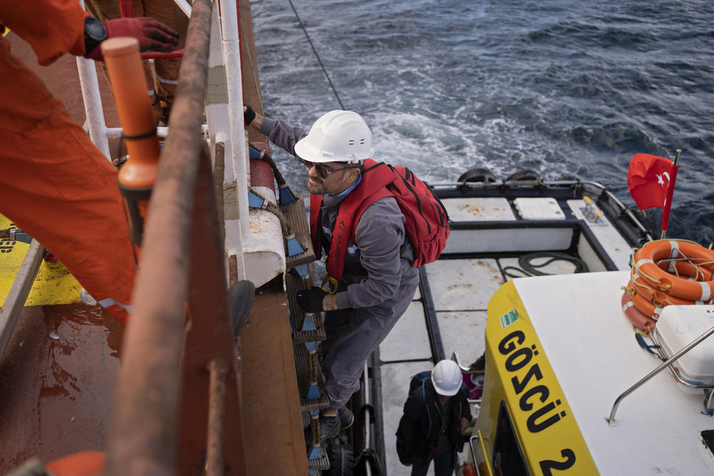 United Nations inspector Cristian Santos climbs aboard the Tzarevich, a 40-foot climb on a swaying rope ladder. Depending on the size of the vessel, the climb can be as high as 70 feet.