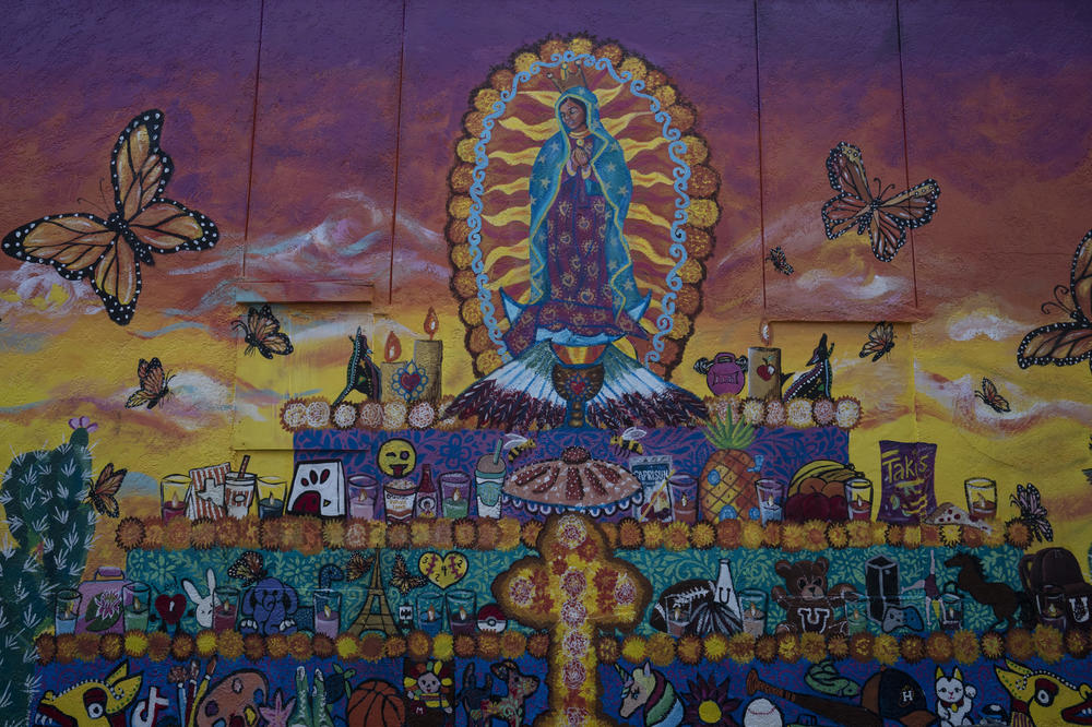 A mural painted by artists Lizbeth Ortiz and Leticia Santos depicting an altar for the children and teachers who were killed during the mass shooting at Robb Elementary School.
