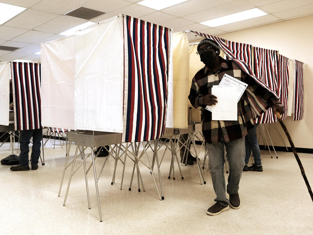 People cast early ballots in the upcoming midterm elections at a polling station on Tuesday in Anchorage, Alaska.