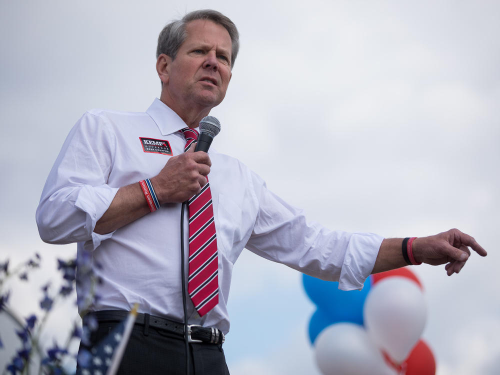 Republican Gov. Brian Kemp speaks to supporters at a campaign stop in Marietta, Ga., on Nov. 3. Kemp emphasized how he kept businesses open during the pandemic despite criticism from Democrats and health experts. 