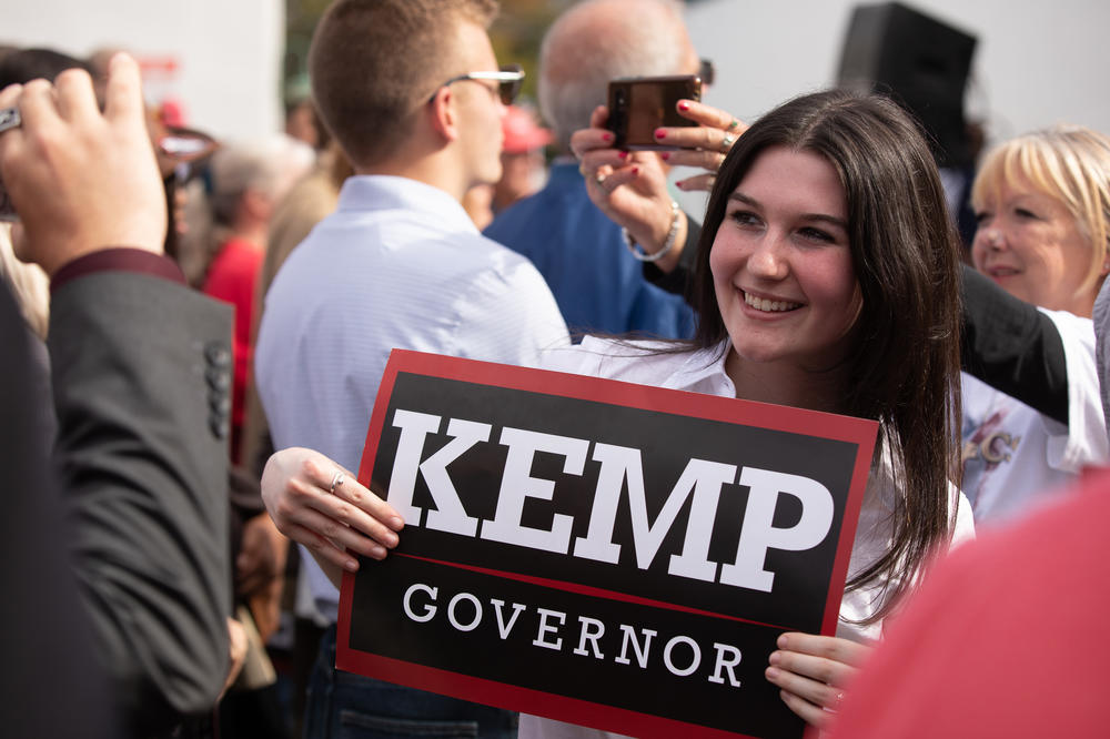 Kemp supporters snap selfies as the governor joins Pence onstage at a campaign rally in Cumming, Ga. on Nov. 1.