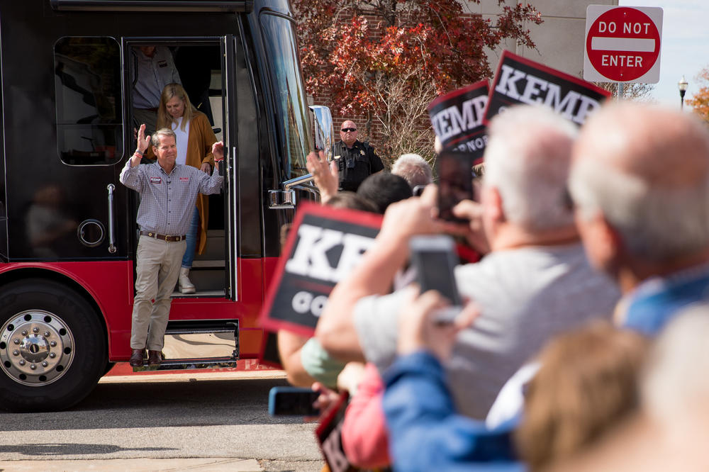 A crowd of more than a hundred supporters cheers as Kemp steps off his campaign bus in Cumming, Ga., on Nov. 1 just ahead of a rally featuring former Vice President Mike Pence.