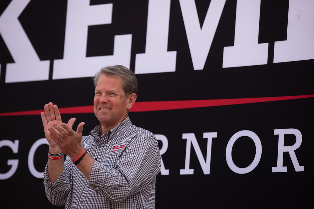 Kemp smiles as Pence touts the governor's leadership during a rally in Cumming, Ga., on Nov. 1. 
