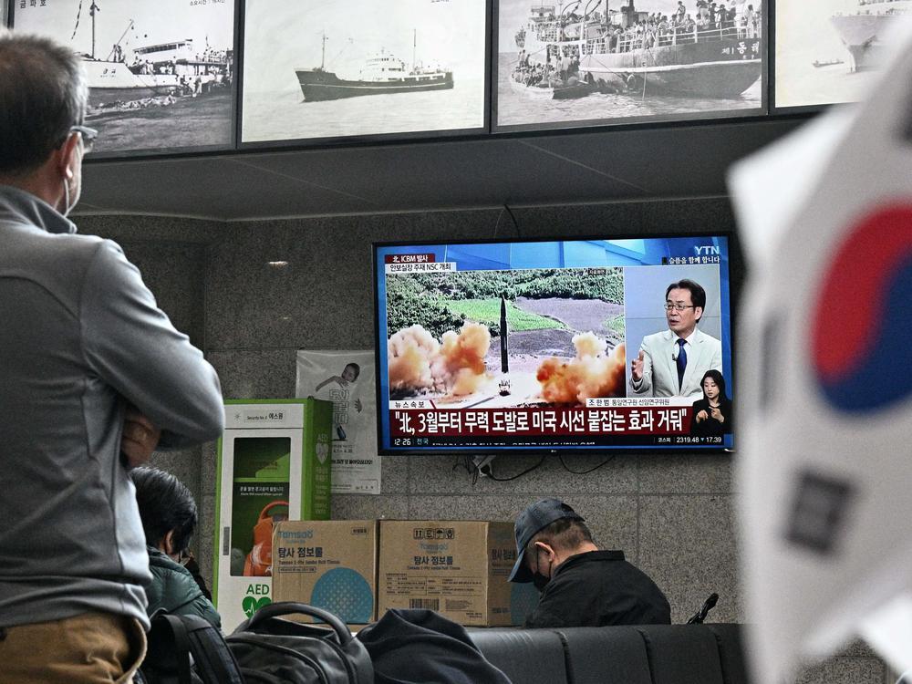 Visitors watch a news broadcast showing file footage of a North Korean missile test at the ferry terminal of South Korea's eastern island of Ulleungdo, in the East Sea, also known as the Sea of Japan, on Thursday.