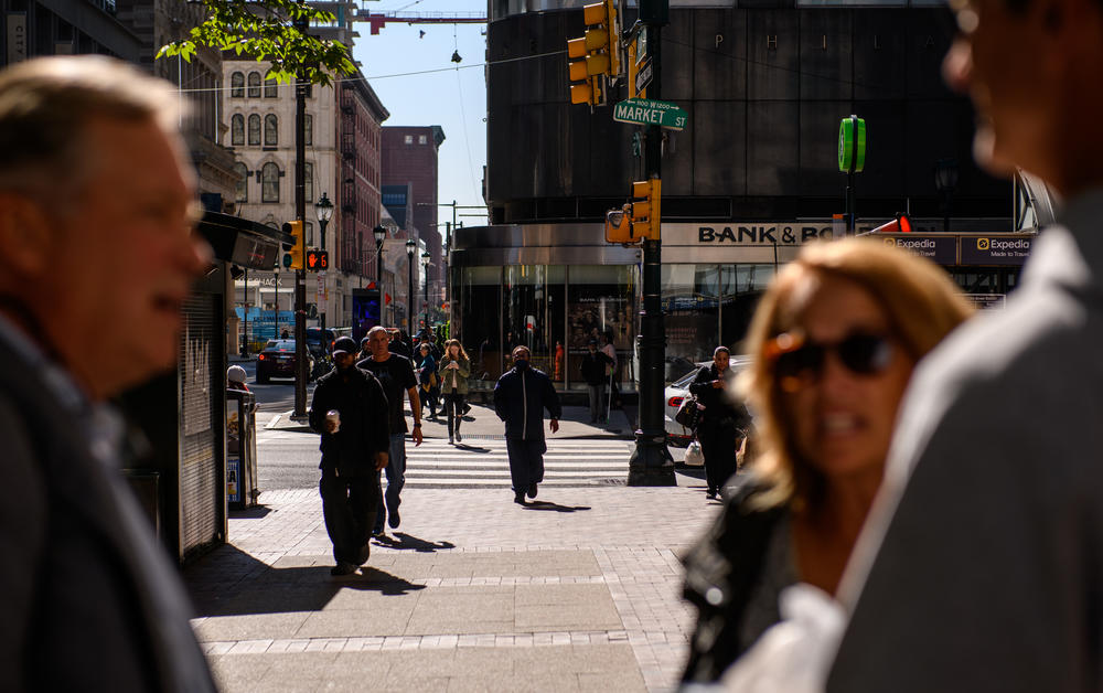 Pedestrians cross an intersection in the Center City section of Philadelphia on Friday, October 21, 2022.